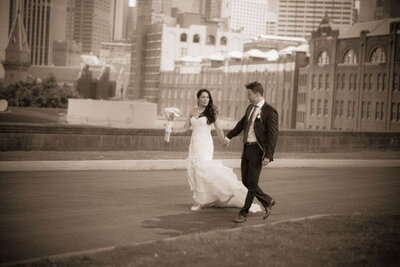formal bride and groom standing by the car with a flowing veil