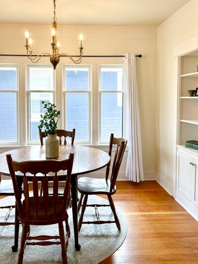 Dining room in Everett staged by Modern Mollusk featuring wood furniture, natural light, and neutral decor.