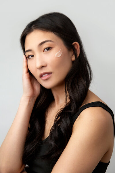 a model with a skincare swatch on her cheek