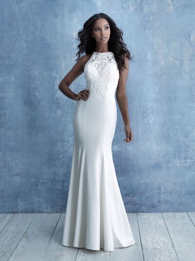 Symmetrical beaded appliques adorn the bodice and high neckline of this crepe sheath gown.
