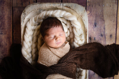 Beautiful newborn photography: Newborn girl wrapped in pink, ivory and rhinestones