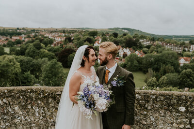 Couple kissing in countryside wedding portraits