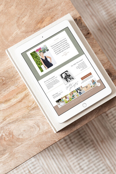 Ipad sitting on table with brand photographer website