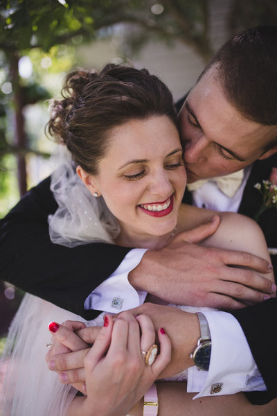 first-look-groom-kiss-backyard-wedding