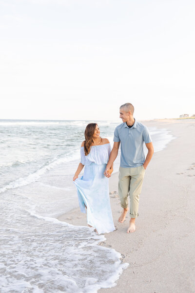 couple walking down beach sunset waves lavallette nj