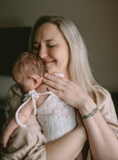 mom holding baby during session with Beaverton photographer