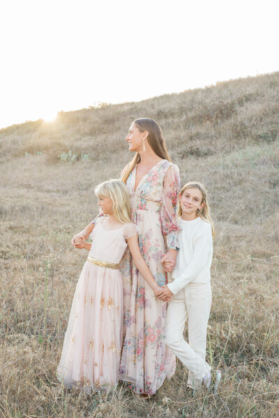 Family Photographer, woman lifting her little boy over her head near the ocean