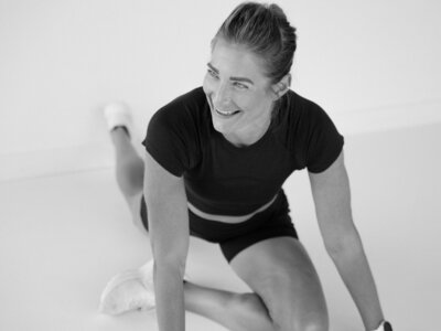 Lululemon ambassador stretching before a run, highlighting athleticism and preparation in a vibrant brand photography session.
