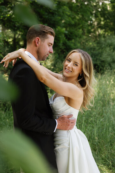 Bride and her bridesmaids in colorful dresses walking outside in the bright sun