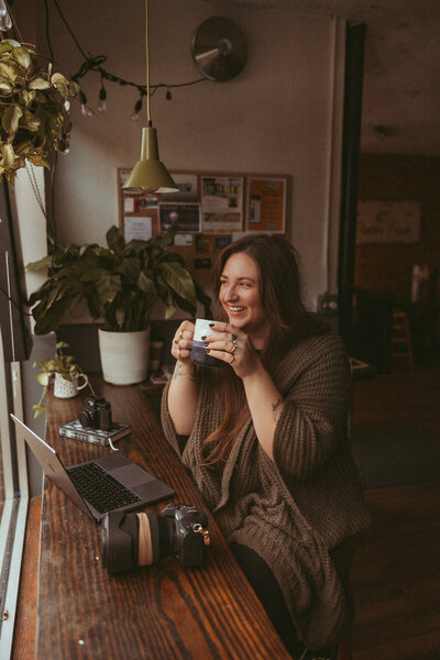 Three Bridge Photography posing in a coffee shop during branding session