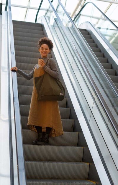 woman going up an escalator.