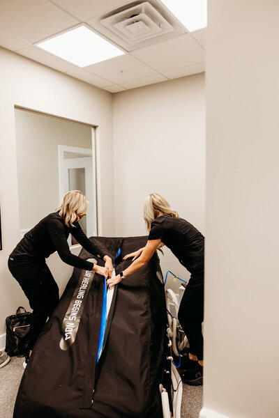 Woman helping client into chamber