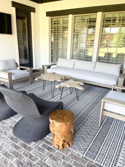 Personalized interior design for home in an outdoor living room with grey and white decorations, creating a serene and elegant atmosphere for relaxation.