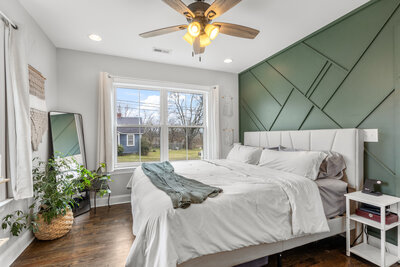 staged bedroom with green accent wall