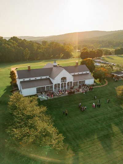 Drone view of mountains and barn at Castle Hill Cider during cocktail hour