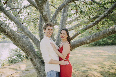 Spring Lake | Smiling couple posing by a tree during engagement session | Monmouth County, New Jersey