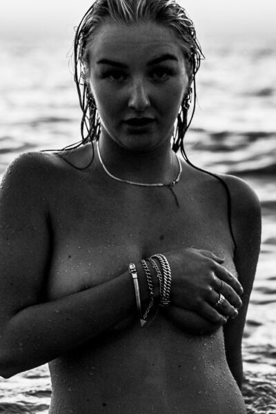 Confident pose in the shallow tide, with the ocean reflecting her strength