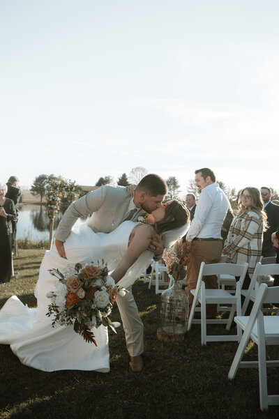 bride and groom in aisle for first kiss after wedding ceremony at wedding venue bortner valley in upperco maryland