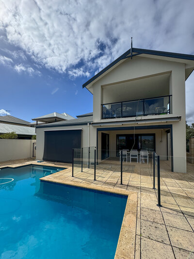 Two story house with pool and glass fencing