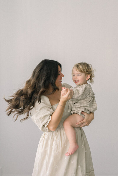 women twirling little girl both smiling knoxville tennessee newborn photographer