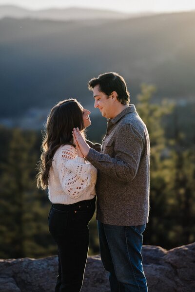 Fiance embraces during Colorado mountain proposal.