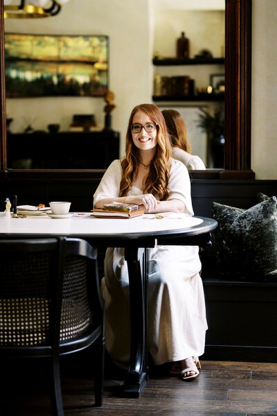 monica sitting at table