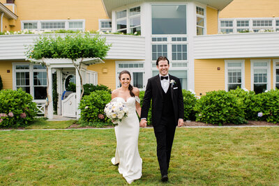 bride and groom walking in front of Ocean House