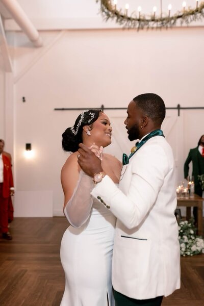 Couple doing their first dance in indoor reception