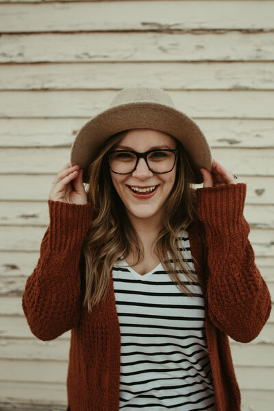 woman smiling and wearing hat
