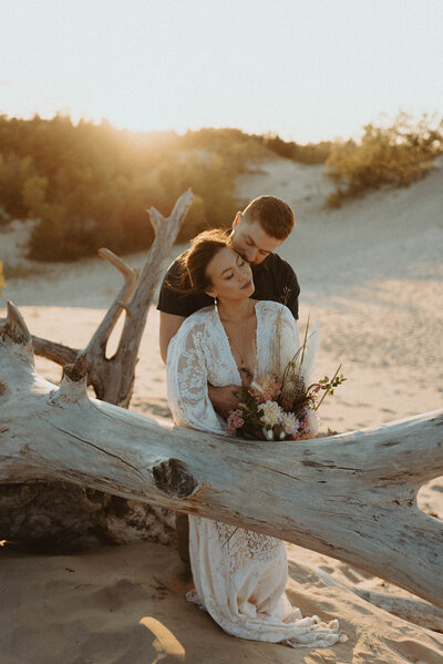 bride and groom hugging at sunset