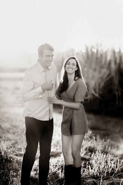 Engagement couple laughing in black and white photo