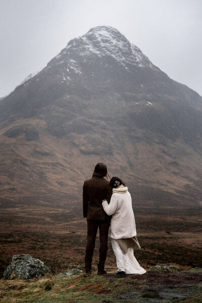 couple stand at bottom of mountain during glencoe elopement