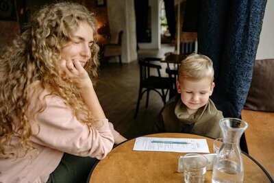 Parents relaxing with coffee while kids play safely in the background