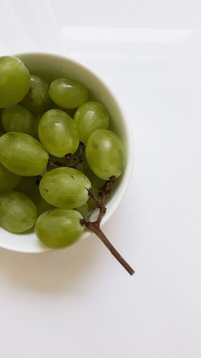 green grapes in a white bowl