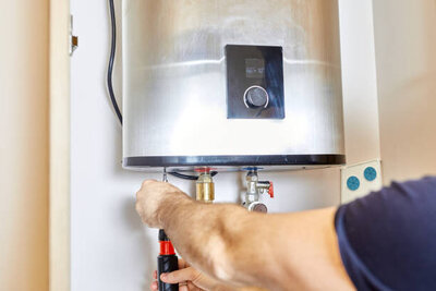 tankless water heater with plumber installing 