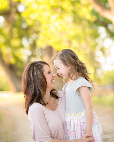 mom and daughter looking at each other and laughing in Boise, ID