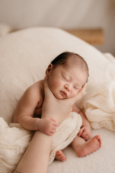 Photo of a newborn baby wearing a knitted romper