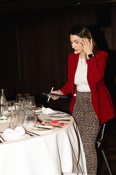 Emma, an Ireland Wedding Planner and Stylist, holding an iPad