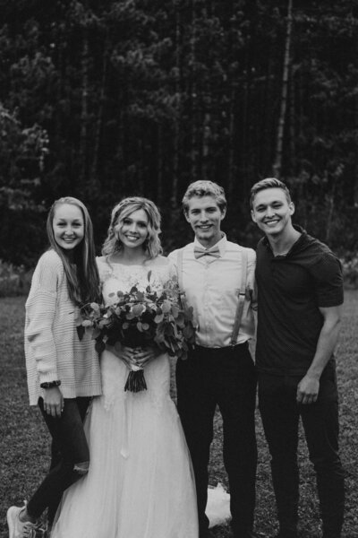 Photo of a wedding couple and their photographer