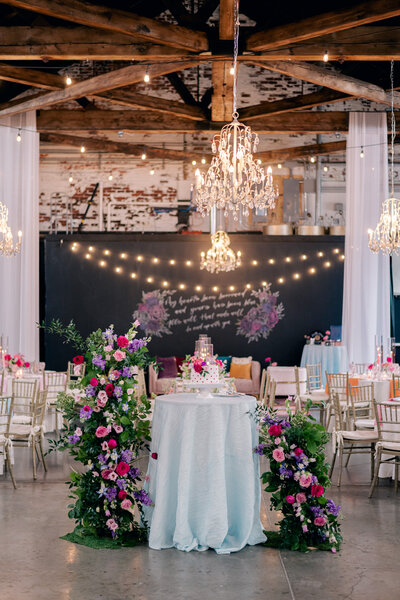 Rustic indoor wedding reception at The Brightside, featuring exposed brick and string lights.