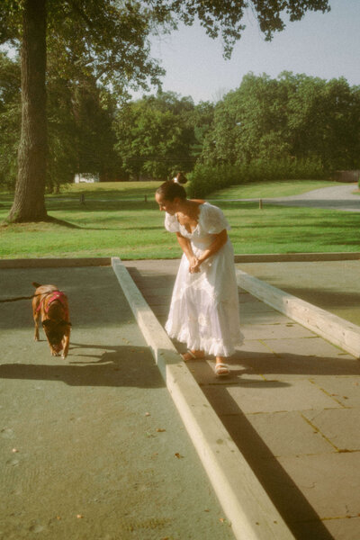 Bride shares a sweet moment with dog during her rehearsal at her destination wedding weekend. 