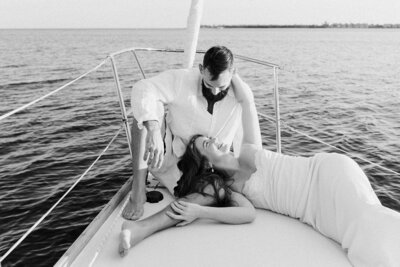 newlyweds smiling at each other on a boat