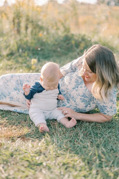 mom-laying-with-baby-on-ground
