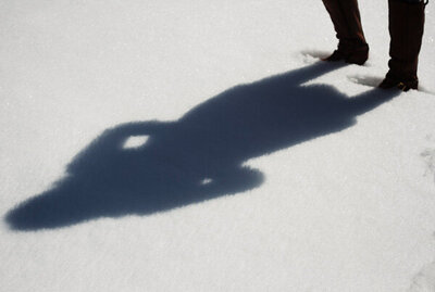Branding Photo of Author Linda Brooks shadow on snow