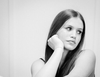 Black and white teen portrait side-glancing, soft expression, senior session