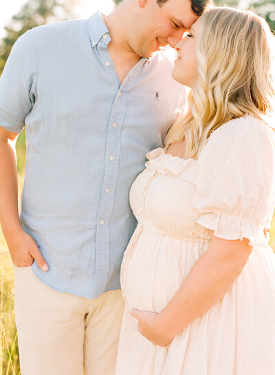 Mom and dad snuggling during a Raleigh maternity session. Photographed by Raleigh maternity photographer A.J. Dunlap Photography
