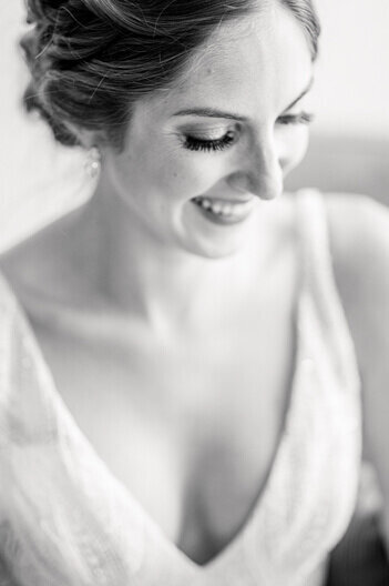 black and white photo of bride laughing on her wedding day