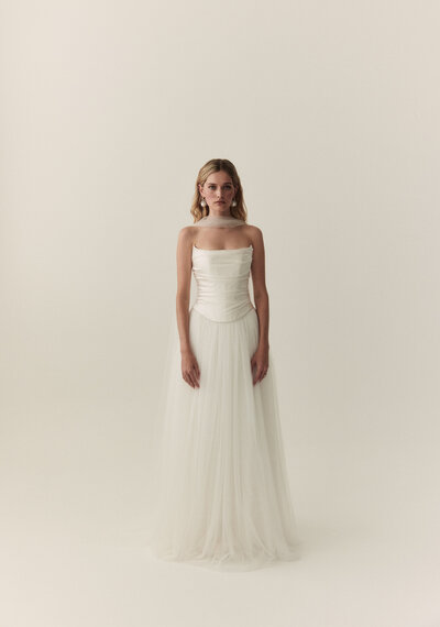 black and white image bride wearing strapless satin wedding dress with long train