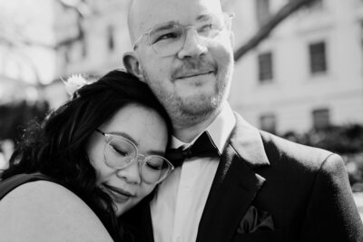 Black and white wedding image of couple, woman with eyes closed and head snuggled into man's shoulder. Couples photoshoot Melbourne, And So I Don't Forget Photography