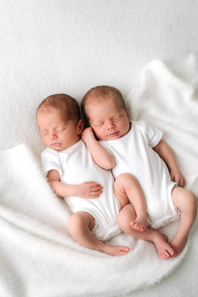 Close up of babies hand inside mum and dads hands at newborn photography session in Billingshurst